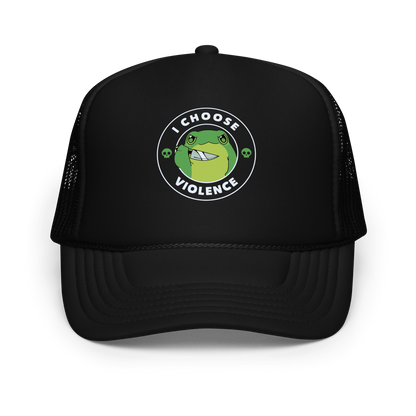 A charming, cartoon-style green frog holds a knife in its hand with a playful yet fierce expression. Encircled by bold text, 'I CHOOSE VIOLENCE,' the design mixes humor with an edge. Two small skulls flank the frog, adding a quirky, rebellious touch to the image. The overall effect balances cuteness and irony in a memorable way.