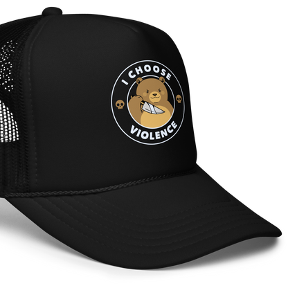 A cartoon-style image features a cute, determined-looking teddy bear holding a knife, with an expression of mischief. The bear is surrounded by the bold text 'I CHOOSE VIOLENCE' and accompanied by small skull icons on either side, adding a humorous and ironic twist to the design.