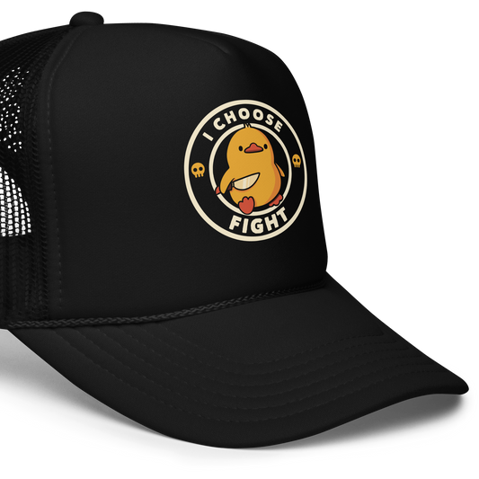 The image displays a cute, cartoon-style yellow duck character holding a knife with a determined expression. The duck is centered inside a circular design with the text 'I CHOOSE FIGHT' around it. Two small skulls flanking the duck add a humorous, combative touch to the design.