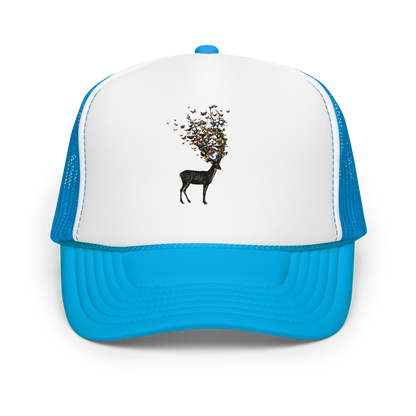 The image depicts a dark, silhouetted deer standing on a neutral background. Instead of branches, its antlers transform into a swirling cloud of vibrant, colorful butterflies that extend upwards and outward. The mix of organic and ethereal elements creates a captivating and whimsical visual contrast.