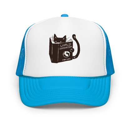 The design features a black silhouette of a cat peeking from behind an oversized book. The book's cover reads 'World Domination for Cats,' and includes a simple drawing of a globe. The cat's eyes are wide open, suggesting either surprise or intense focus on its 'world domination' plans.