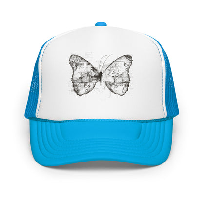 The image features a black and white butterfly where the wings are created using ancient world map designs. The maps overlay in intricate detail, blending geographical elements with the organic shape of the butterfly. Surrounding the butterfly are faint outlines of text and additional geographic features, creating a vintage and exploratory vibe.