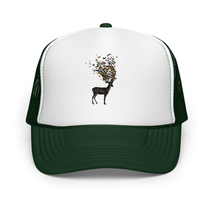 The image depicts a dark, silhouetted deer standing on a neutral background. Instead of branches, its antlers transform into a swirling cloud of vibrant, colorful butterflies that extend upwards and outward. The mix of organic and ethereal elements creates a captivating and whimsical visual contrast.