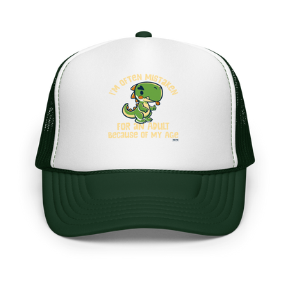 Cute cartoon dinosaur standing with a funny expression, accompanied by the humorous phrase “I’m Often Mistaken for an Adult Because of My Age” in bold distressed lettering.