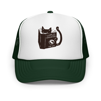 The design features a black silhouette of a cat peeking from behind an oversized book. The book's cover reads 'World Domination for Cats,' and includes a simple drawing of a globe. The cat's eyes are wide open, suggesting either surprise or intense focus on its 'world domination' plans.