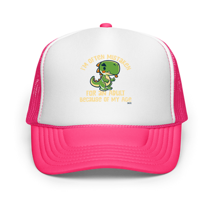 Cute cartoon dinosaur standing with a funny expression, accompanied by the humorous phrase “I’m Often Mistaken for an Adult Because of My Age” in bold distressed lettering.