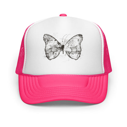 The image features a black and white butterfly where the wings are created using ancient world map designs. The maps overlay in intricate detail, blending geographical elements with the organic shape of the butterfly. Surrounding the butterfly are faint outlines of text and additional geographic features, creating a vintage and exploratory vibe.