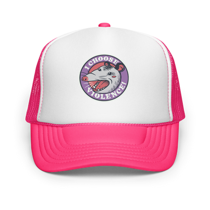 A circular design featuring an opossum with an open mouth showing sharp teeth, set against a red and purple background. Surrounding the animal, the text reads 'I Choose Violence!' in bold, white letters. The opossum has a somewhat comical yet aggressive expression. The design has an edgy, cartoon-like style, suitable for various products like t-shirts and stickers.