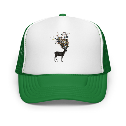 The image depicts a dark, silhouetted deer standing on a neutral background. Instead of branches, its antlers transform into a swirling cloud of vibrant, colorful butterflies that extend upwards and outward. The mix of organic and ethereal elements creates a captivating and whimsical visual contrast.