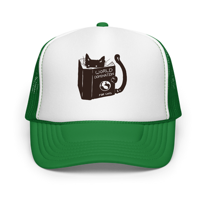 The design features a black silhouette of a cat peeking from behind an oversized book. The book's cover reads 'World Domination for Cats,' and includes a simple drawing of a globe. The cat's eyes are wide open, suggesting either surprise or intense focus on its 'world domination' plans.