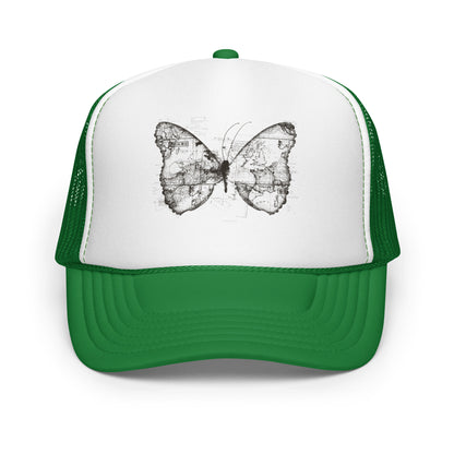 The image features a black and white butterfly where the wings are created using ancient world map designs. The maps overlay in intricate detail, blending geographical elements with the organic shape of the butterfly. Surrounding the butterfly are faint outlines of text and additional geographic features, creating a vintage and exploratory vibe.