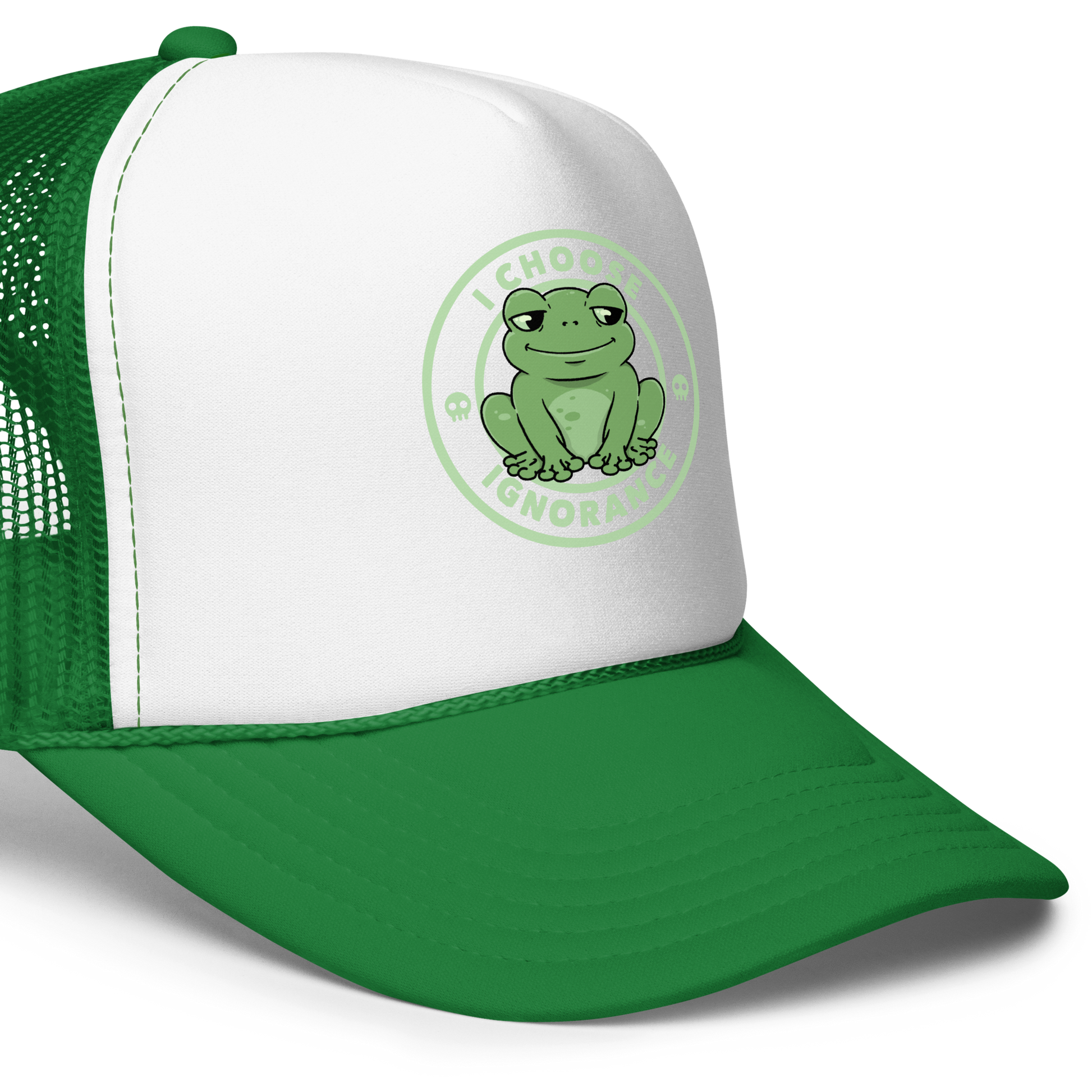 The image shows a cartoonish green frog with a sly smile, sitting with legs splayed out. Around it, the phrase 'I CHOOSE IGNORANCE' is written in bold letters. Two small skull designs are included, one on each side of the frog. The style is playful and ironic, blending elements of humor and rebellion.