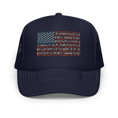 American flag illustration made entirely of retro video game icons, controllers, characters, and symbols in blue, red, and beige, arranged to form the stars and stripes.