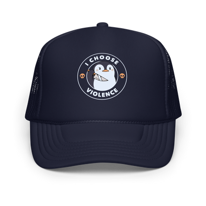 A cartoon-style penguin with a slightly menacing expression holds a large knife. It is surrounded by the words 'I CHOOSE VIOLENCE' in bold uppercase letters. There are two small orange skulls flanking the penguin. The overall design is circular and features contrasting colors for a dramatic effect.