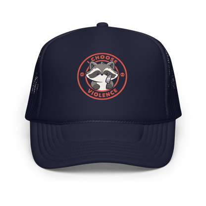 A cute cartoon raccoon character stands with a small knife, surrounded by a red circular border with the text 'I CHOOSE VIOLENCE'. The raccoon looks adorable yet mischievous, with a playful expression. Two small skulls are on either side of the circle, adding humor to the bold statement.