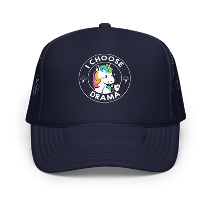 A cartoon unicorn with rainbow-colored mane holds a cup of tea and a heart, encircled by the words 'I Choose Drama'. Two small clouds with lightning bolts flank the unicorn, adding a playful yet slightly edgy vibe. The design is bold and whimsical with a pop-art influence.