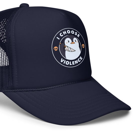 A cartoon-style penguin with a slightly menacing expression holds a large knife. It is surrounded by the words 'I CHOOSE VIOLENCE' in bold uppercase letters. There are two small orange skulls flanking the penguin. The overall design is circular and features contrasting colors for a dramatic effect.