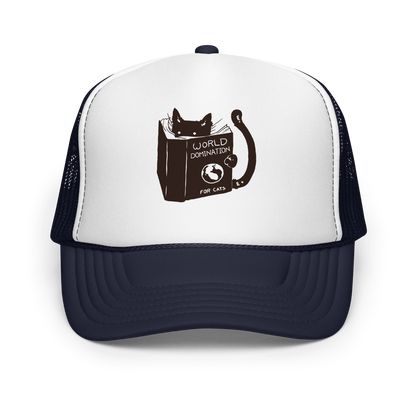 The design features a black silhouette of a cat peeking from behind an oversized book. The book's cover reads 'World Domination for Cats,' and includes a simple drawing of a globe. The cat's eyes are wide open, suggesting either surprise or intense focus on its 'world domination' plans.