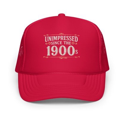 Vintage-style graphic with the phrase “Unimpressed Since the 1900s” in bold distressed lettering, decorated with ornate flourishes and a retro color palette.