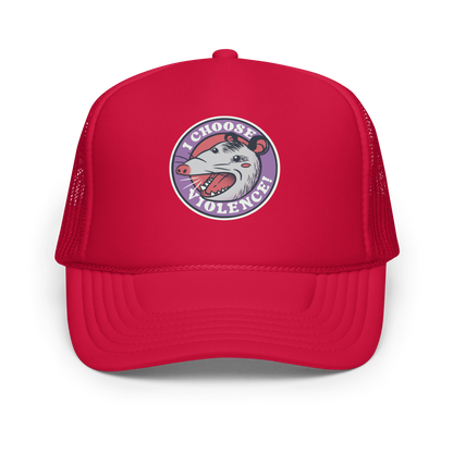 A circular design featuring an opossum with an open mouth showing sharp teeth, set against a red and purple background. Surrounding the animal, the text reads 'I Choose Violence!' in bold, white letters. The opossum has a somewhat comical yet aggressive expression. The design has an edgy, cartoon-like style, suitable for various products like t-shirts and stickers.