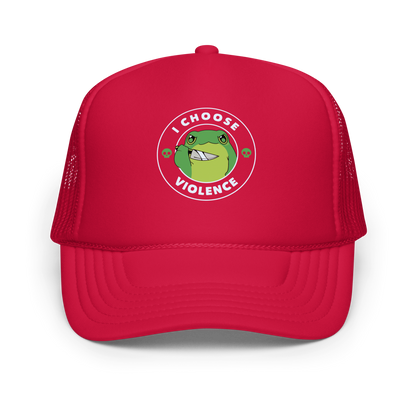 A charming, cartoon-style green frog holds a knife in its hand with a playful yet fierce expression. Encircled by bold text, 'I CHOOSE VIOLENCE,' the design mixes humor with an edge. Two small skulls flank the frog, adding a quirky, rebellious touch to the image. The overall effect balances cuteness and irony in a memorable way.