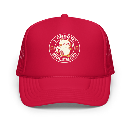 The image features a cute, cartoon-style cat holding a knife in one hand, while standing with an assertive expression. The phrase 'I CHOOSE VIOLENCE!' surrounds the cat in a circular layout. Two small cat skull and crossbones illustrations flank either side of the cat. The design combines elements of cuteness and aggression, creating a humorous and ironic vibe.