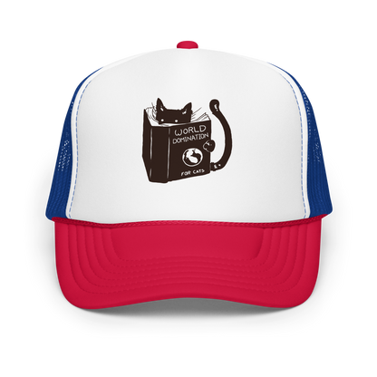 The design features a black silhouette of a cat peeking from behind an oversized book. The book's cover reads 'World Domination for Cats,' and includes a simple drawing of a globe. The cat's eyes are wide open, suggesting either surprise or intense focus on its 'world domination' plans.