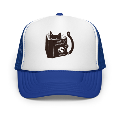 The design features a black silhouette of a cat peeking from behind an oversized book. The book's cover reads 'World Domination for Cats,' and includes a simple drawing of a globe. The cat's eyes are wide open, suggesting either surprise or intense focus on its 'world domination' plans.