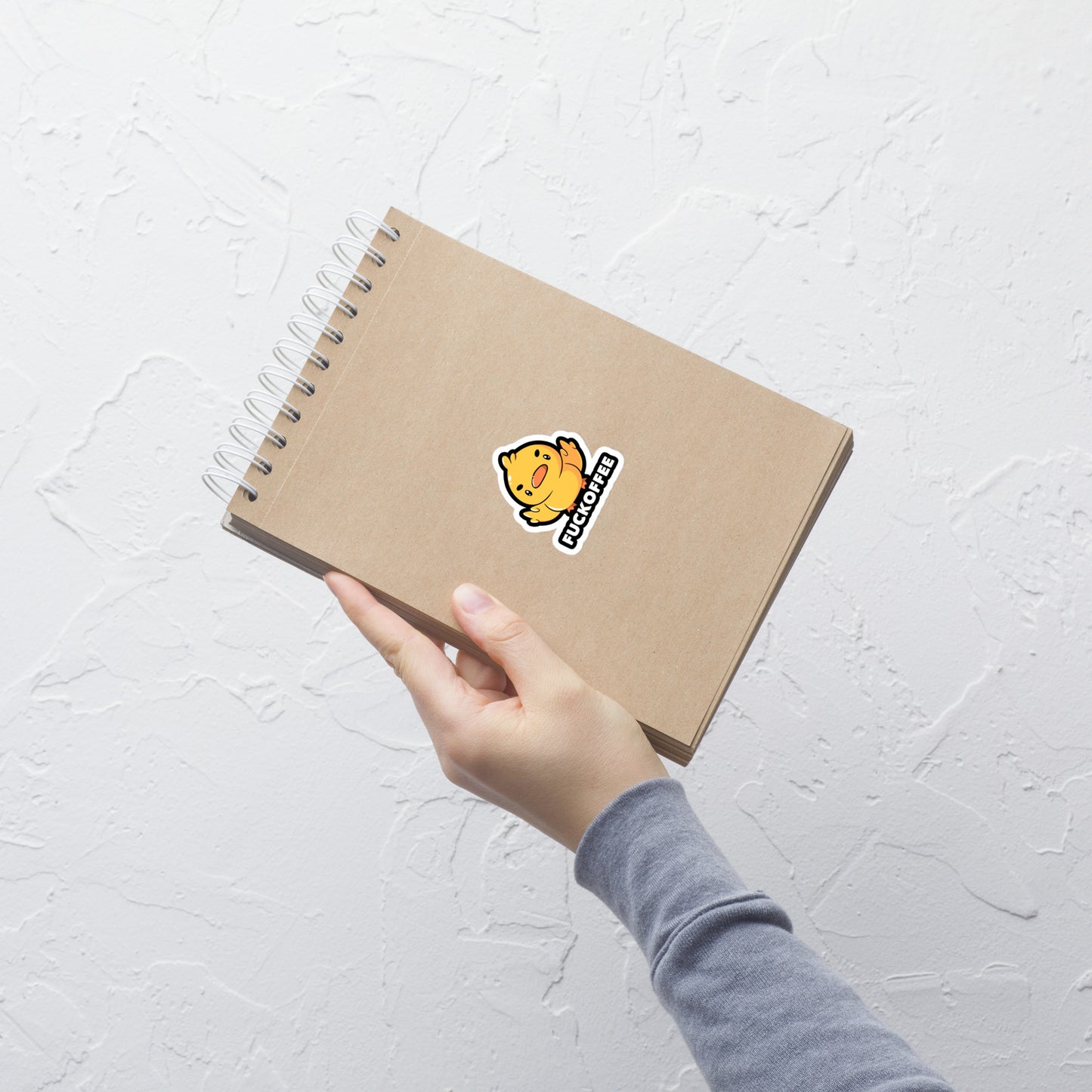 A cute yellow duckling with a mean face showing his middle fingers, next to it the phrase "Fuckoffee". An art with humor for those who love ducks.