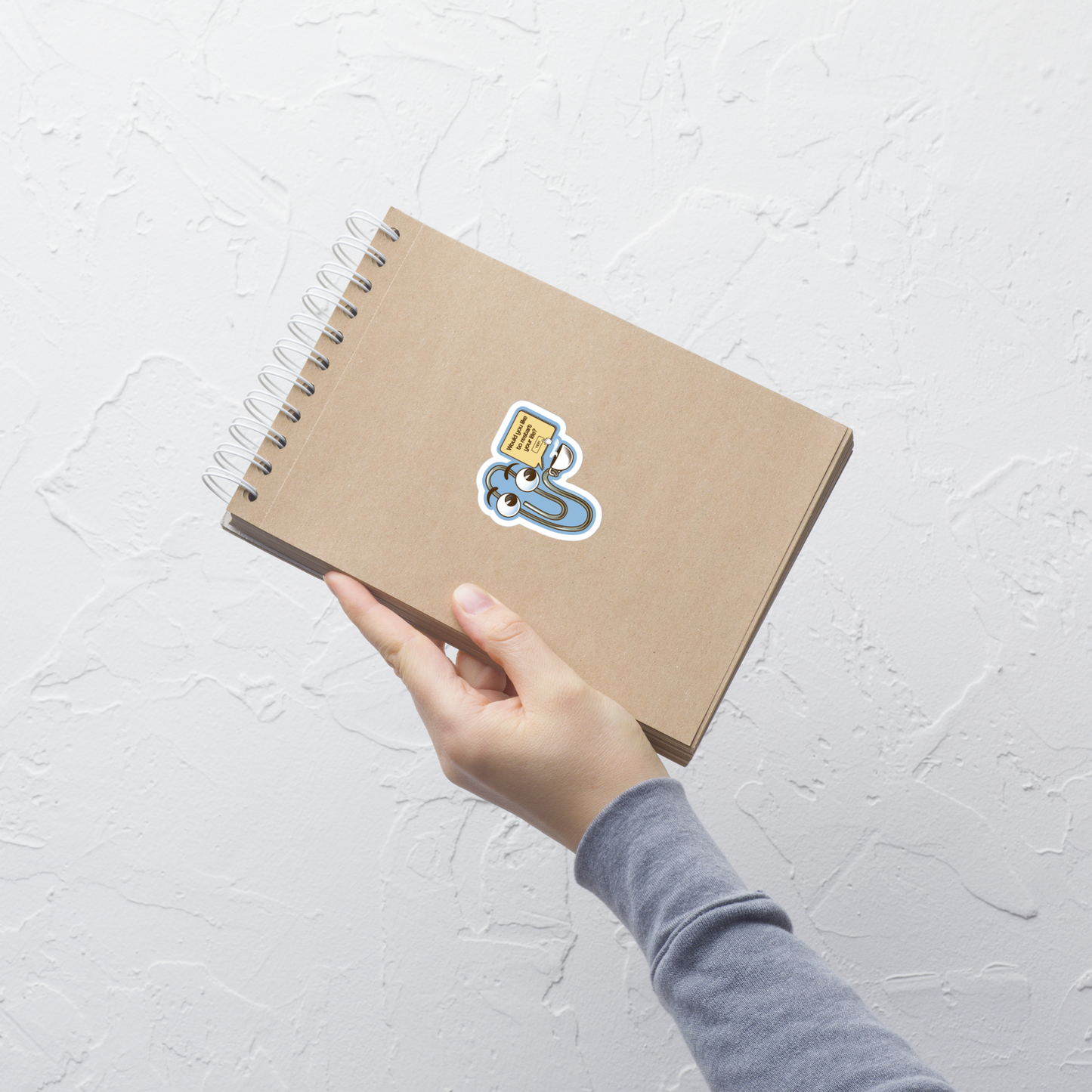 A playful paperclip character holding a cup of coffee with the phrase ‘You Look Like You Need a Coffee’. A witty, nostalgic design perfect for coffee lovers and fans of retro tech humour.