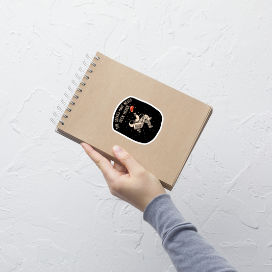 An astronaut floating through space with a small steak in front of him, paired with the phrase ‘The Steaks Have Never Been Higher’. A playful and humorous design that blends space exploration with a clever visual pun. Perfect for fans of witty wordplay and quirky art.