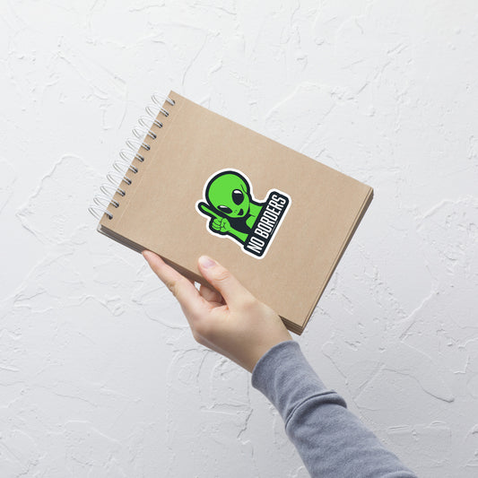 A green alien depicted with a raised finger, accompanied by the phrase "No Borders". 