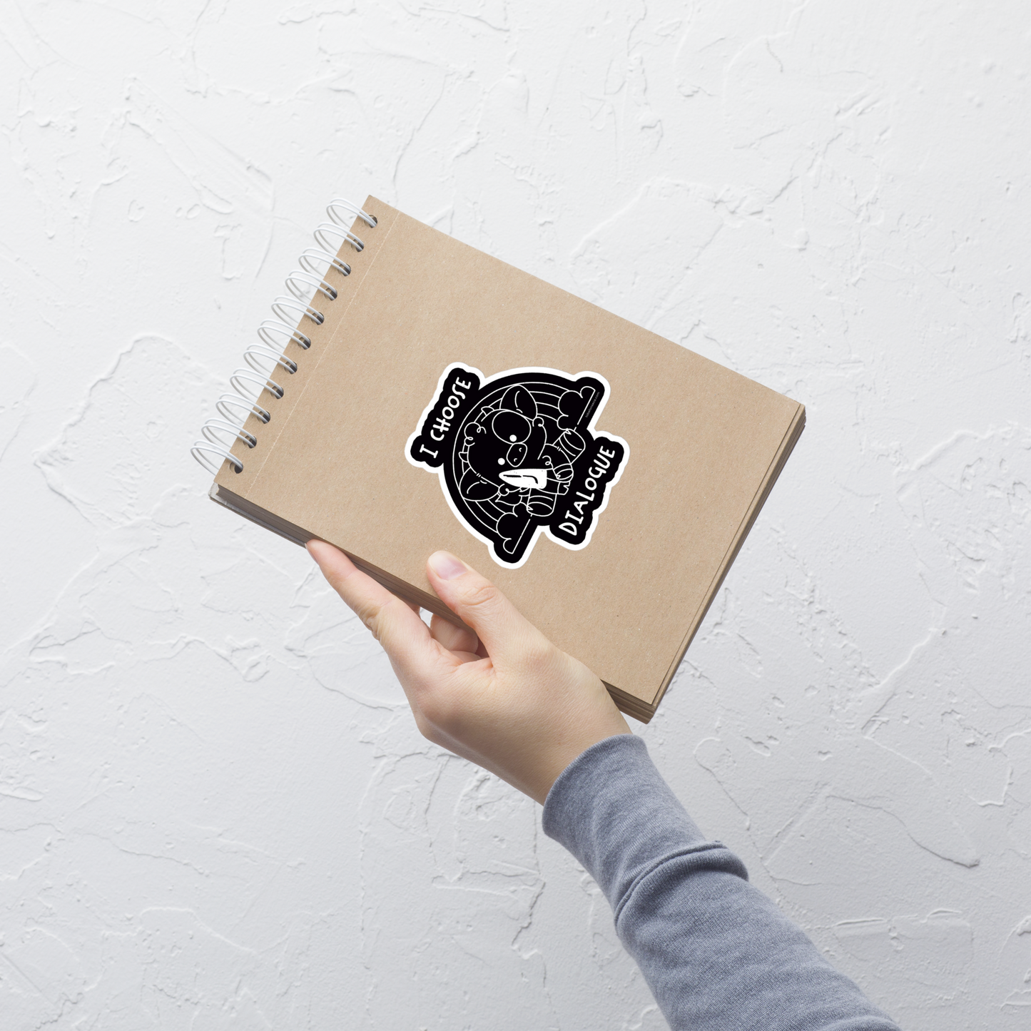 An adorable cow holds a knife while sitting in front of a rainbow, accompanied by the phrase “I Choose Dialogue.” This design combines sweetness and irony to create a fun and unexpected contrast. It’s a great gift for those who enjoy subtle humor and designs that combine cuteness with a touch of irreverence.