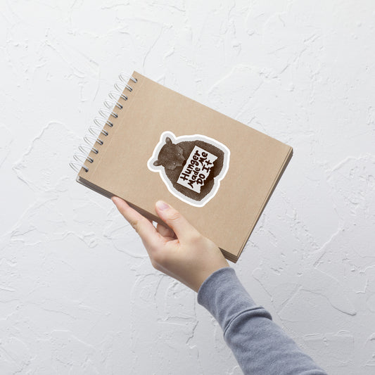 A brown bear holding a sign that reads “Hunger Made Me Do It”. This design plays on that classic bad mood that hits when hunger strikes. Perfect for those who live life with a good sense of humor, food lovers, and people who identify too much with that bad mood caused by hunger.