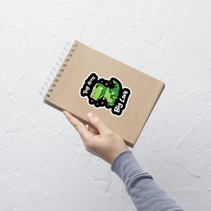 An adorable T-Rex appears in the center, with its short arms and cute smile. This design plays with the contrast between the dinosaur's ferocity and the phrase "Tiny arms, big love," delivering humor and affection. Perfect for those who love geeky, fun, and personality-filled prints, especially dinosaur fans and those with a soft heart.