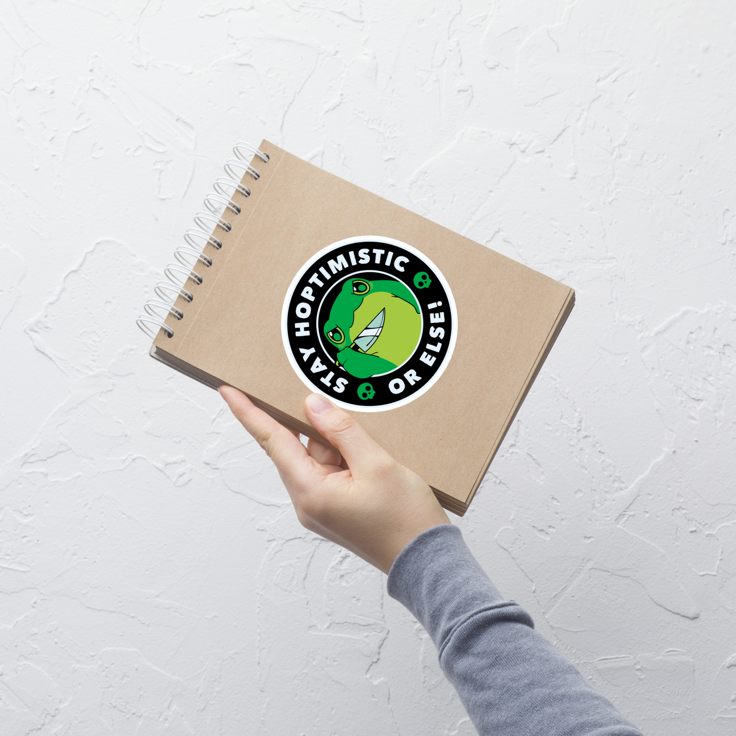 A green frog with a determined look stands beside the playful phrase “Stay Hoptimistic — Or Else”. A fun pun with a slightly chaotic twist, perfect for frog lovers and anyone who enjoys quirky, attitude-filled humor.