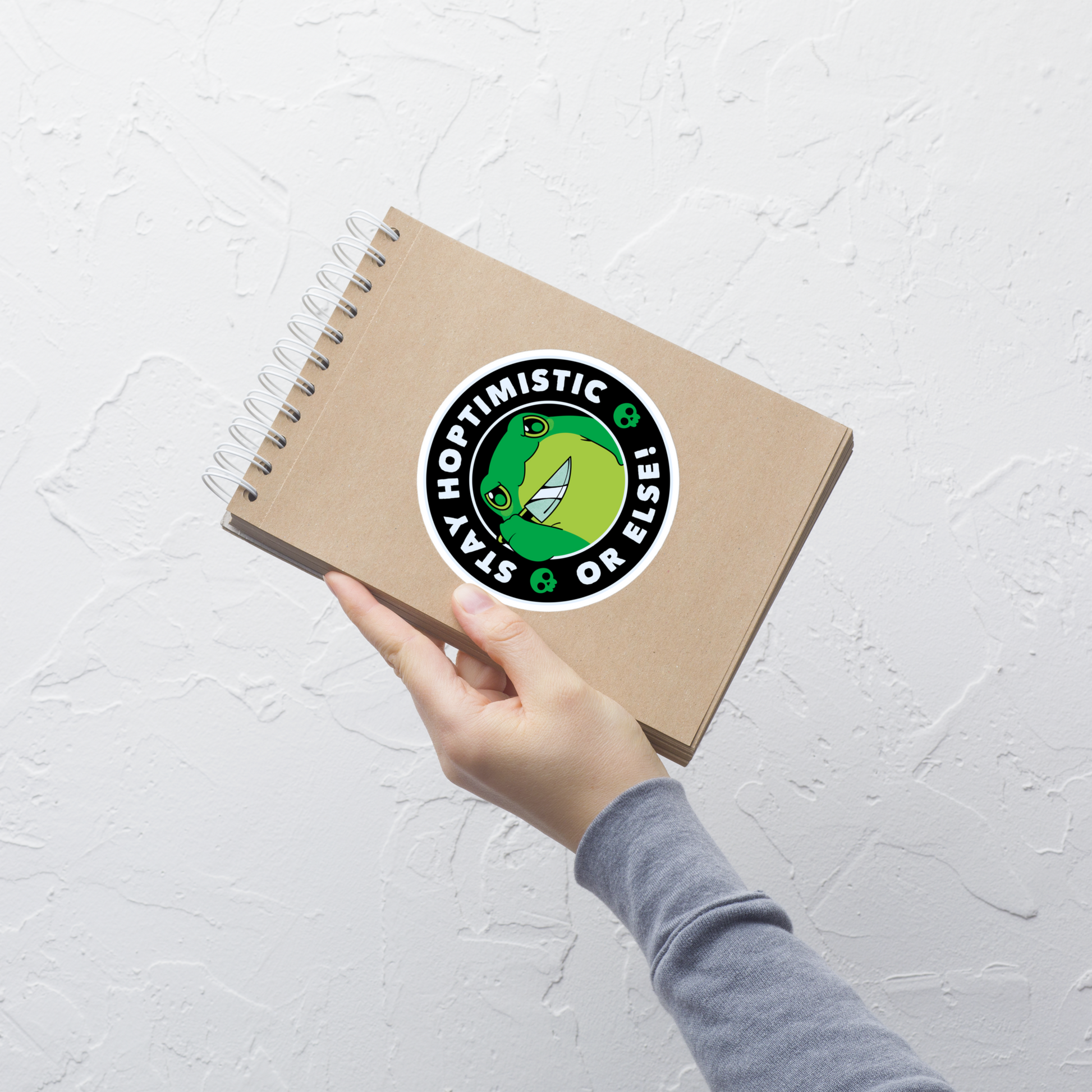 A green frog with a determined look stands beside the playful phrase “Stay Hoptimistic — Or Else”. A fun pun with a slightly chaotic twist, perfect for frog lovers and anyone who enjoys quirky, attitude-filled humor.