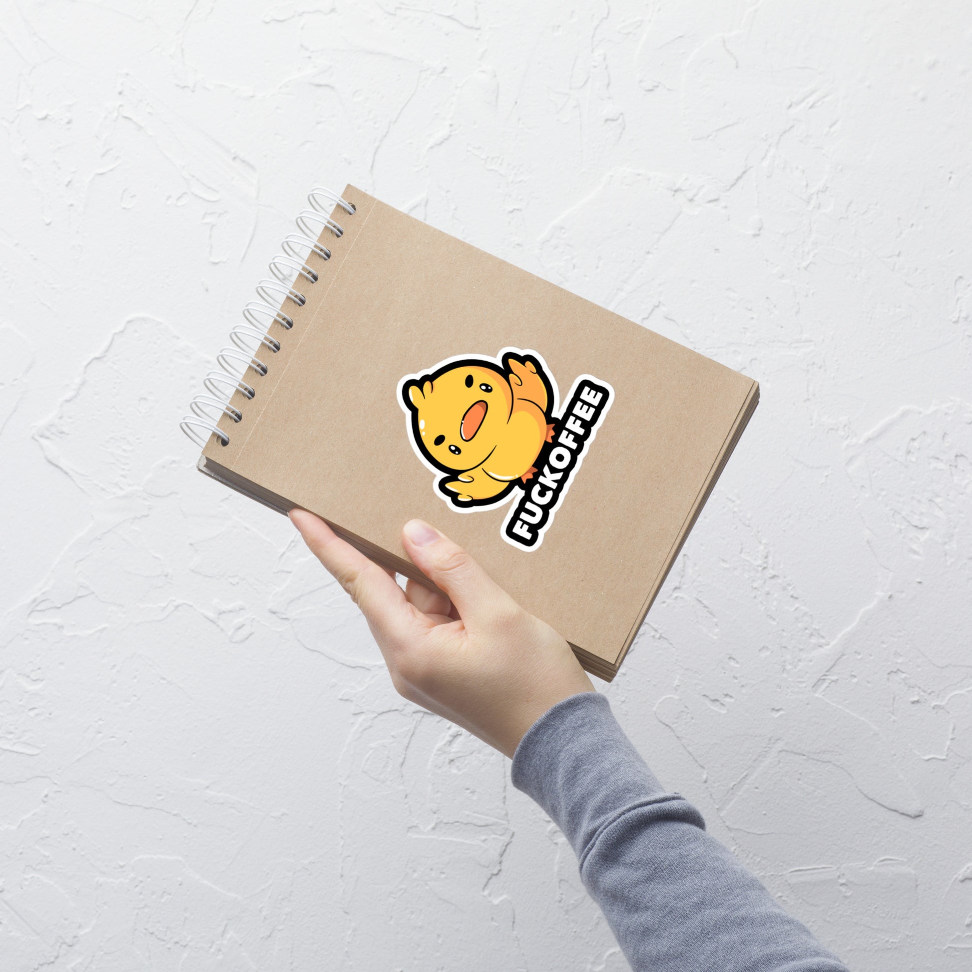 A cute yellow duckling with a mean face showing his middle fingers, next to it the phrase "Fuckoffee". An art with humor for those who love ducks.
