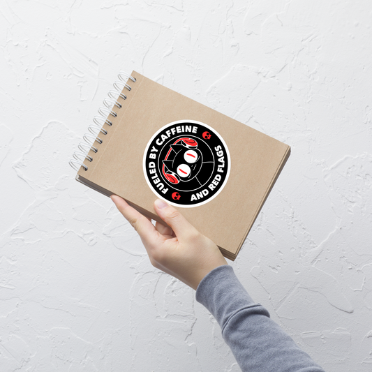 A stamp-style illustration of a black cat wearing headphones, featuring the phrase “Fueled by Caffeine and Red Flags”. A humorous and ironic design perfect for coffee lovers, chaotic souls, and anyone who embraces their red flags with style.