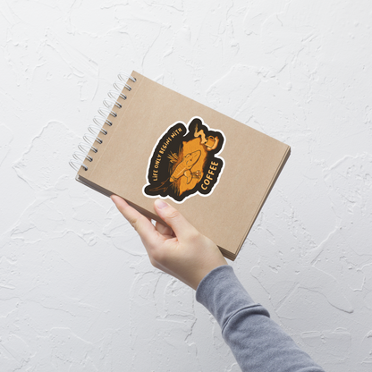 This funny illustration shows a tadpole evolving into a terrestrial creature while reaching for a cup of coffee. Paired with the phrase ‘Life Begins After Coffee Evolution’, the artwork humorously compares human evolution to our daily need for coffee.