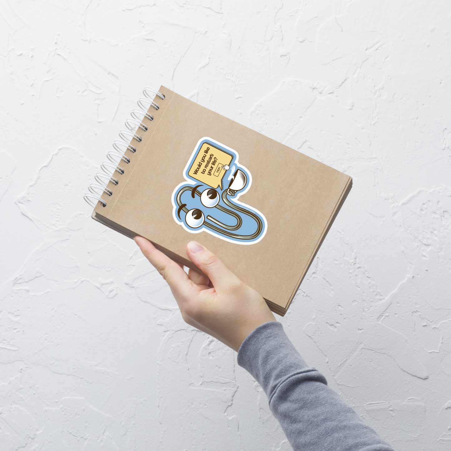 A playful paperclip character holding a cup of coffee with the phrase ‘You Look Like You Need a Coffee’. A witty, nostalgic design perfect for coffee lovers and fans of retro tech humour.