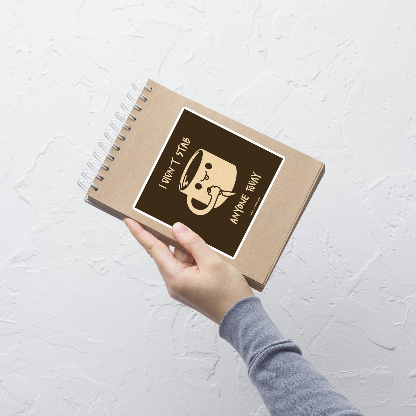 A fun illustration of a smiling coffee mug holding a knife, paired with the phrase “I Didn’t Stab Anyone Today”. A sarcastic, coffee-lover design that celebrates patience, caffeine, and getting through the day with humour.