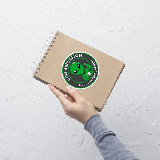 A cute alien holding a cup of coffee, paired with the phrase ‘Cow Abduction For Latte Consumption’. A playful and humorous design that mixes sci-fi vibes with coffee obsession. Perfect for coffee lovers, alien enthusiasts, and anyone who enjoys quirky, funny art with a cosmic twist.