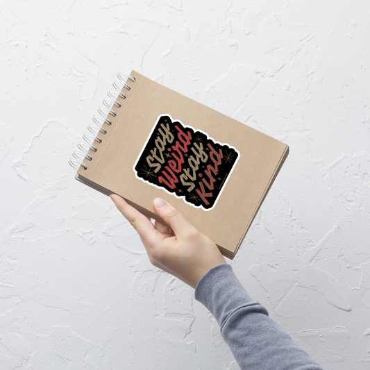 A bold typography design featuring the phrase “Stay Weird Stay Kind” in warm shades of brown and red. A simple yet striking piece that celebrates individuality and kindness with personality and charm.