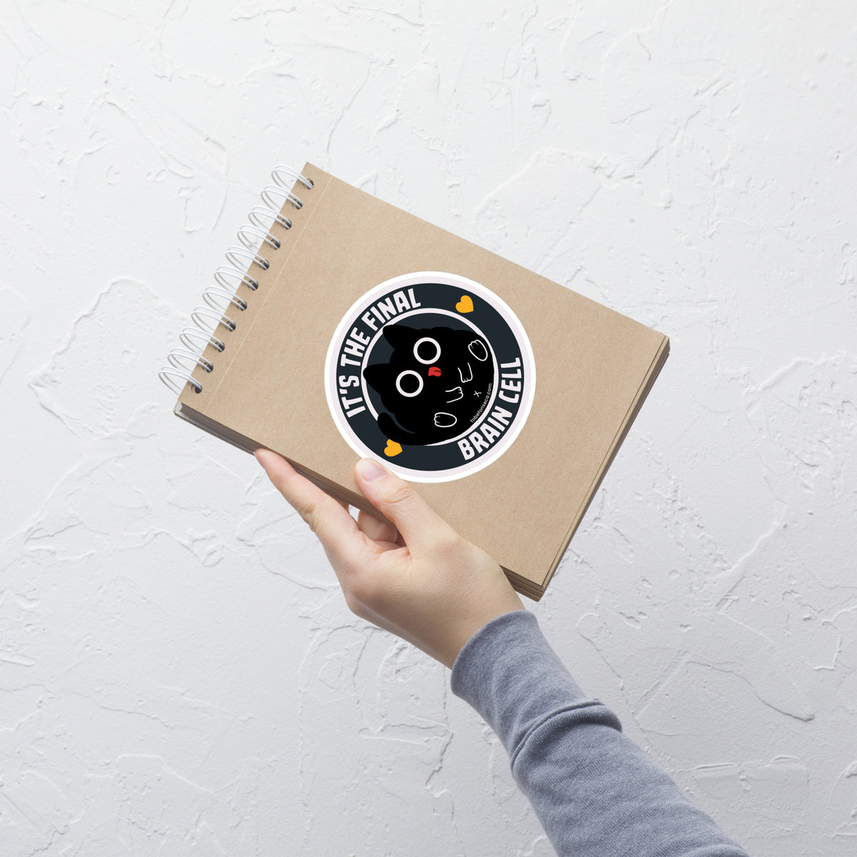 A minimalist label-style illustration featuring a plump black cat sitting in the center with the phrase ‘It’s The Final Brain Cell’. A playful design perfect for cat lovers and anyone who relates to that last surviving brain cell moment.