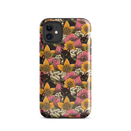 The image features a repeating pattern of colorful flowers in pink, yellow, and cream hues with lush green foliage. Interspersed among the flowers are playful black cats with bright eyes. The design has a whimsical and vibrant feel, ideal for various products like t-shirts, stickers, coffee cups, and skateboards. The style is reminiscent of traditional floral art blended with playful elements of animal decor.