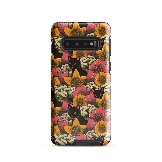 The image features a repeating pattern of colorful flowers in pink, yellow, and cream hues with lush green foliage. Interspersed among the flowers are playful black cats with bright eyes. The design has a whimsical and vibrant feel, ideal for various products like t-shirts, stickers, coffee cups, and skateboards. The style is reminiscent of traditional floral art blended with playful elements of animal decor.