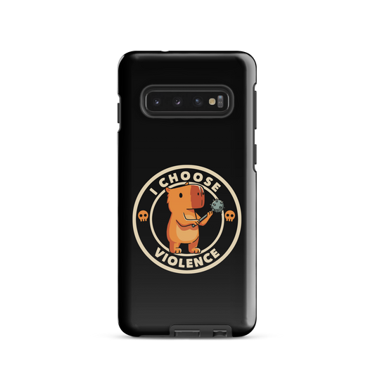 A cute, cartoonish burnt yellow capybara stands holding a spiked mace with a determined expression. Surrounding it is a circular design with the text 'I CHOOSE VIOLENCE' and two small skulls on either side, giving it a humorous yet ironic tone.