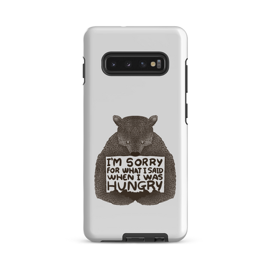 The image shows a humorous, detailed illustration of a bear, drawn in a hand-drawn style, holding a sign that reads 'I'm sorry for what I said when I was hungry.' The bear appears to be apologizing in a comical, endearing manner, making it a relatable and light-hearted design.