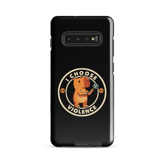A cute, cartoonish burnt yellow capybara stands holding a spiked mace with a determined expression. Surrounding it is a circular design with the text 'I CHOOSE VIOLENCE' and two small skulls on either side, giving it a humorous yet ironic tone.